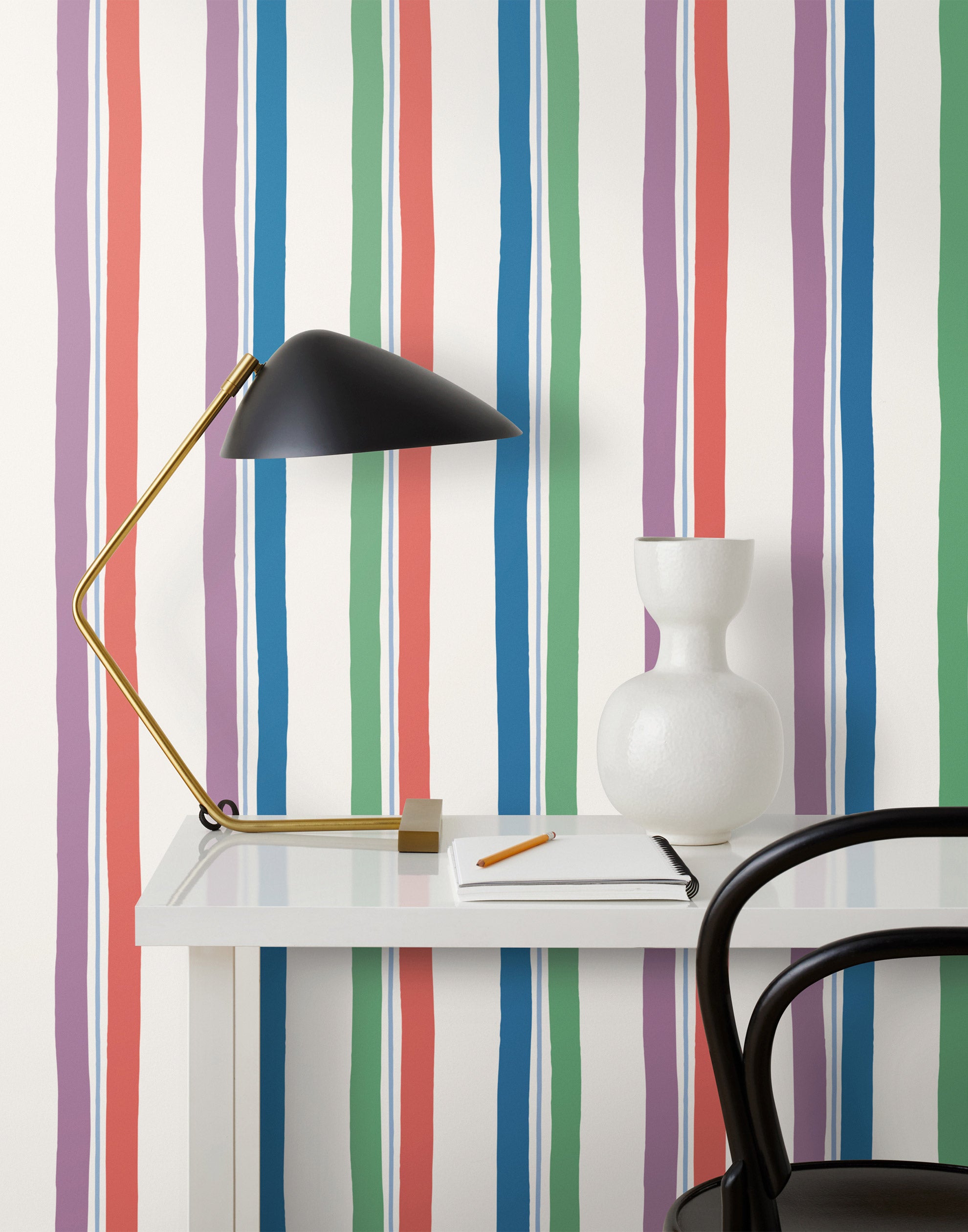 Our Picnic wallpaper was inspired by the wavy stripes of a picnic blanket. Highly durable, fade resistant, and made in the USA. This wallpaper has green, blue, red and purple stripes on a white background and was made in collaboration with The Aesthetics of Joy.