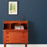 Zinnia (Indigo) Wallpaper mixes a geometric layout with the soft details of the zinnia flower. Black, gray and blue illustration on a navy blue ground.