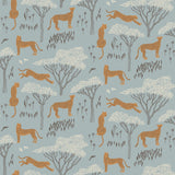 Our Serengeti wallpaper features brown cheetahs and birds scattered among white acacia trees on a dusty blue background, reflecting the powerful beauty of the vast plains. Designed by Julia Rothman and made in the USA.