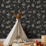Our In the Stars wallpaper is inspired by Urania’s Mirror, a 19th-century set of astrology charts. This hand-drawn pattern evokes the mysterious motion of celestial bodies. This wallpaper features gray and gold motifs on a black background and was designed by Julia Rothman.