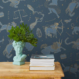 Our In the Stars wallpaper is inspired by Urania’s Mirror, a 19th-century set of astrology charts. This hand-drawn pattern evokes the mysterious motion of celestial bodies. This wallpaper features blue and gold motifs on a navy background and was designed by Julia Rothman.