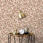 Olive Grove (Bellini) featuring a leafy vine motif in shades of rust and pink with green accents on an off white background | Schoolhouse x Hygge & West Wallpaper Collection
