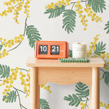 Wallpaper with yellow acacia flowers and green leaves on an off white background | Schoolhouse + Hygge & West