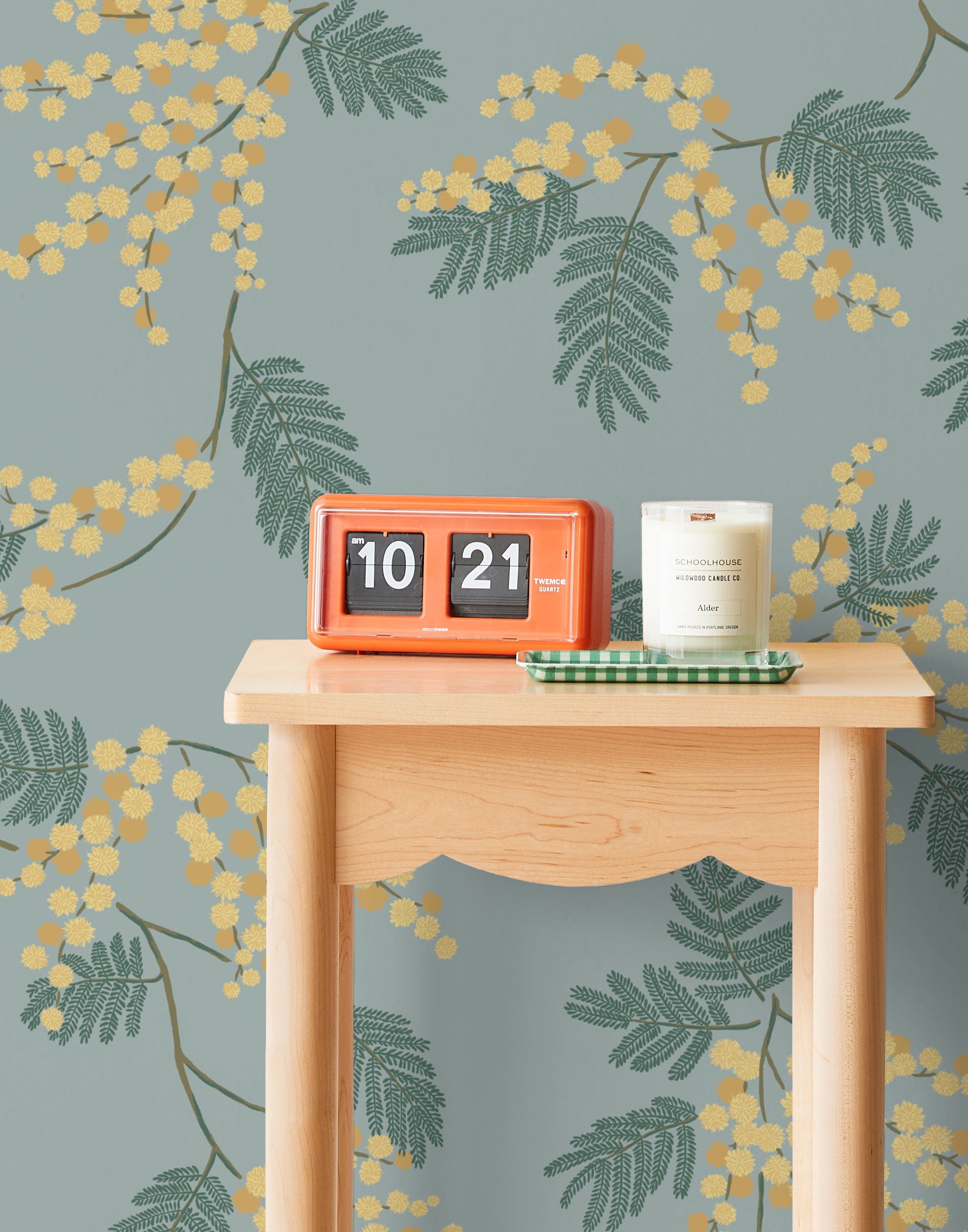 Wallpaper with yellow acacia flowers and green leaves on a dusty blue background | Schoolhouse + Hygge & West