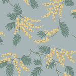 Wallpaper with yellow acacia flowers and green leaves on a dusty blue background | Schoolhouse + Hygge & West