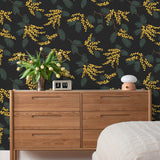 Wallpaper with yellow acacia flowers and green leaves on a soft black background | Schoolhouse + Hygge & West