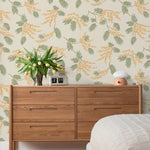 Wallpaper with coral and pink acacia flowers and green leaves on a cream background | Schoolhouse + Hygge & West