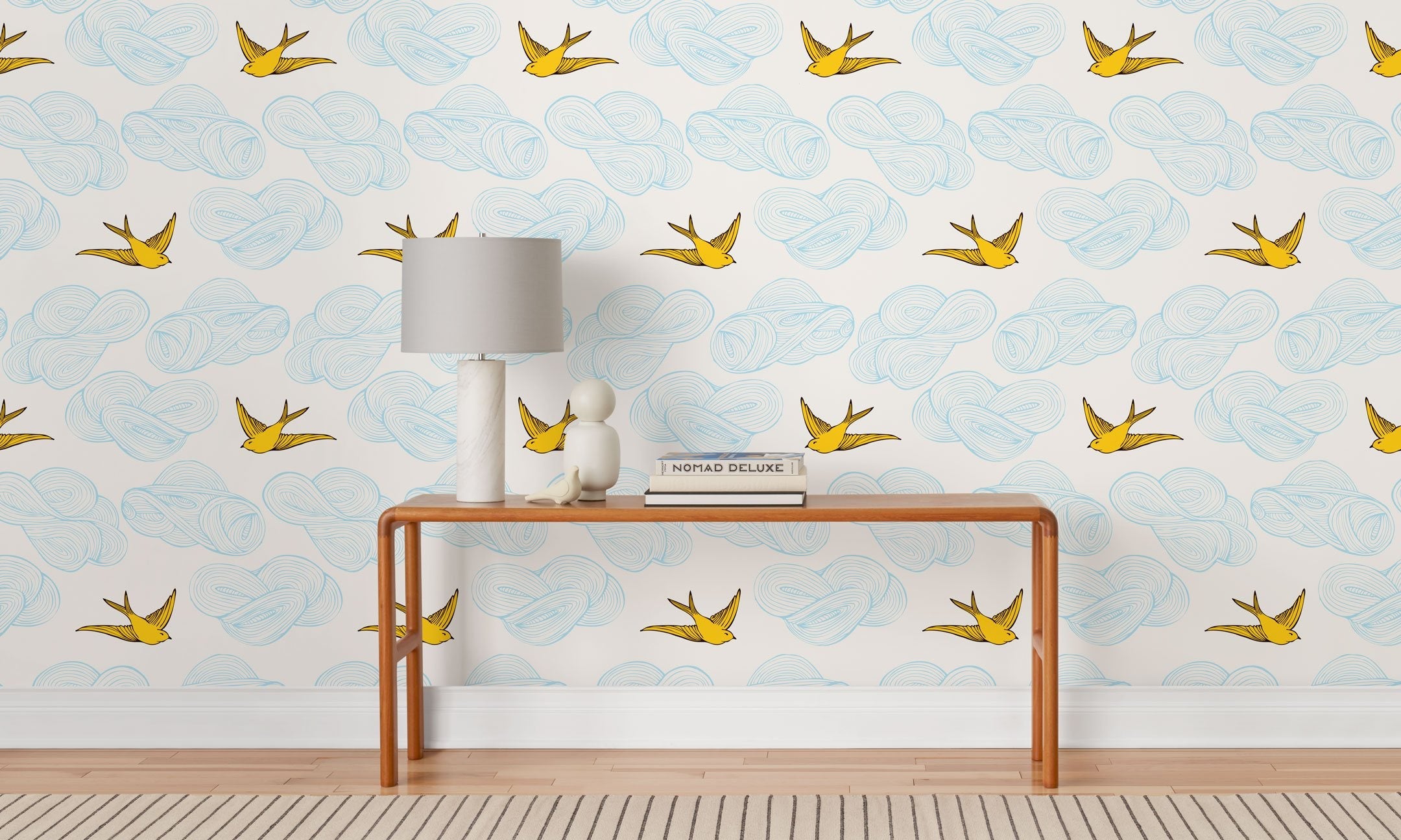 Daydream (Sunshine) features a pattern of flying birds and floating clouds in yellow and blue on white