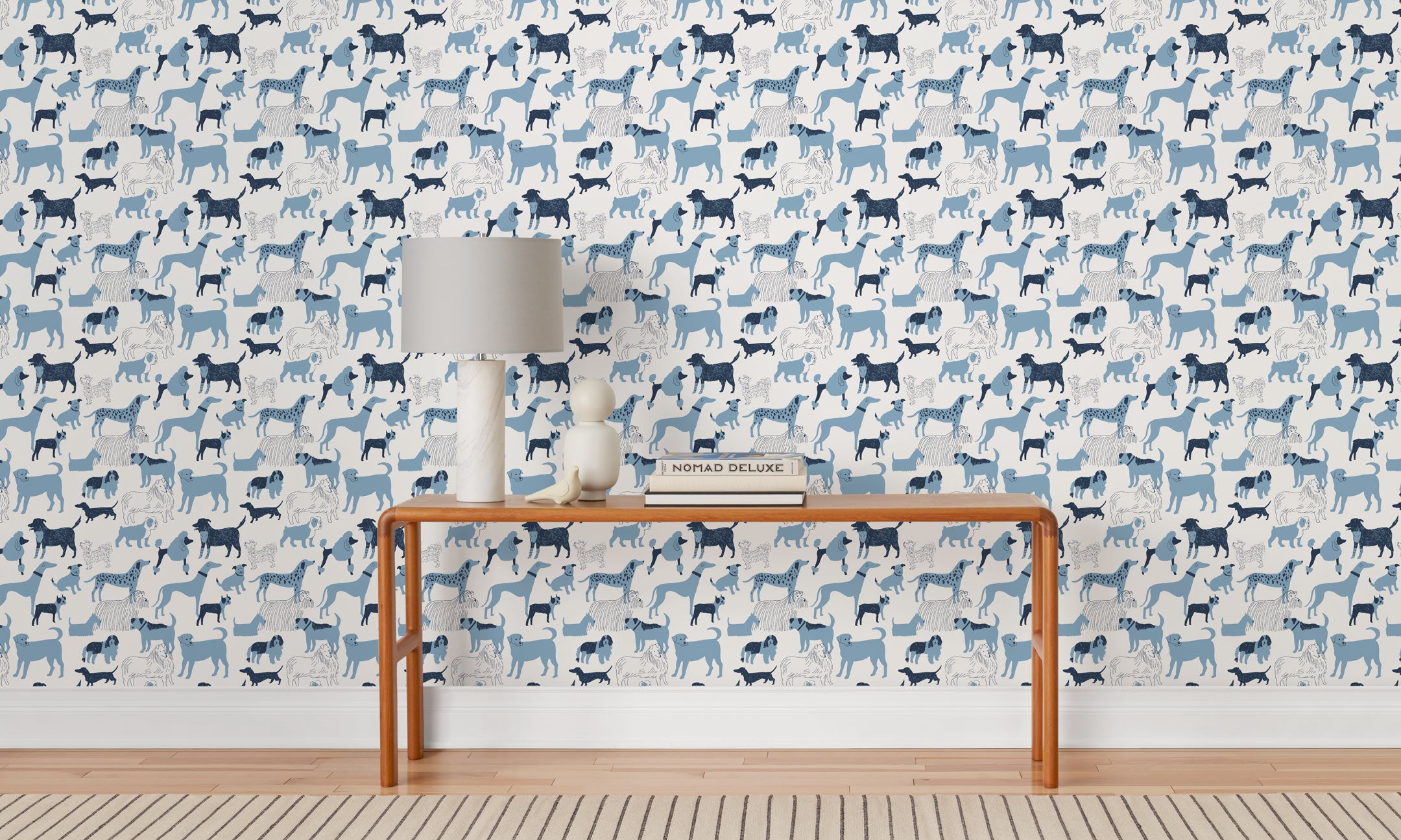 Find your favorite furry friend in our Dog Park pattern, designed in collaboration with Julia Rothman. This wallpaper features blue and navy dogs on a white background. Before and after.