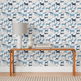 Find your favorite furry friend in our Dog Park pattern, designed in collaboration with Julia Rothman. This wallpaper features blue and navy dogs on a white background. Before and after.