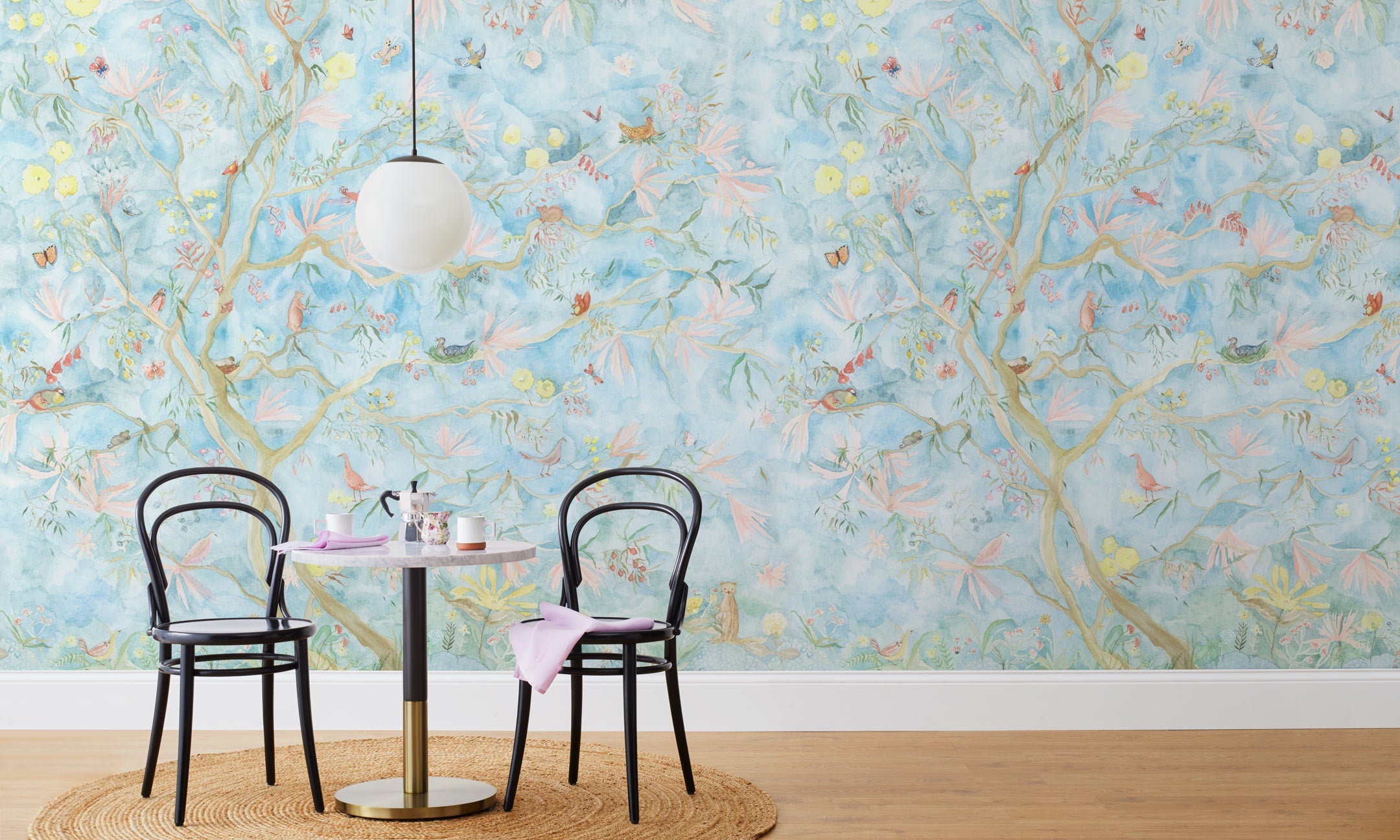 Watercolored birds, butterflies and tree sprites flutter about in an orchard of trees in our Tree Sprites mural. Yellow, pink, peach, and green on a soft blue background. Before and after.