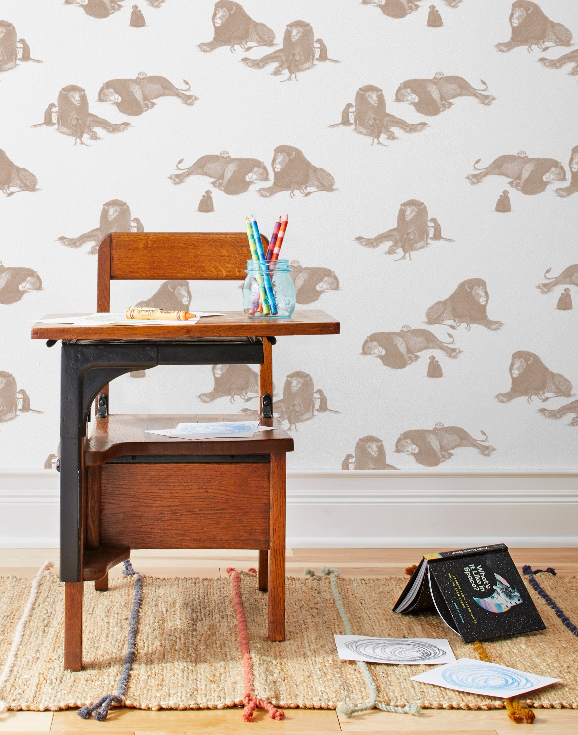 Mighty (Sand) wallpaper features brown lions and meerkats on a white background