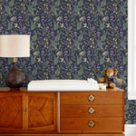 Secret Garden (Amethyst) wallpaper features shades of green, brown, purple, and pink plants, birds and butterflies on dark purple background