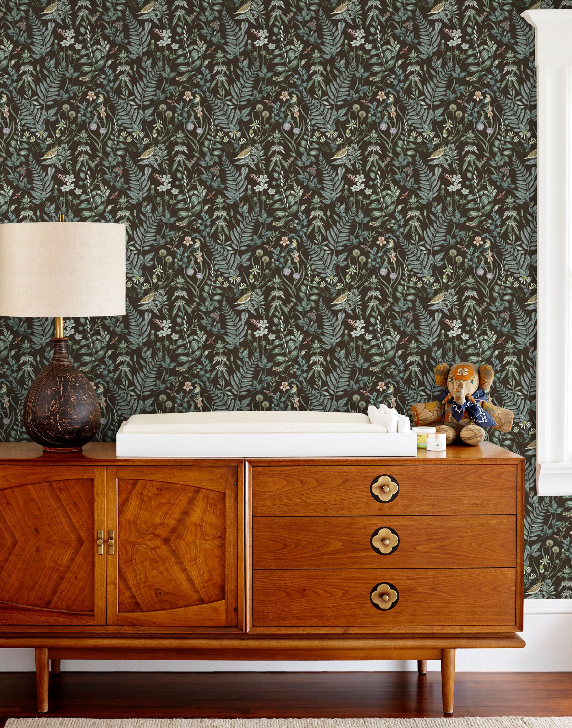 Secret Garden (Sable) wallpaper features shades of green, blue, lilac, and taupe plants, birds and butterflies on brown background