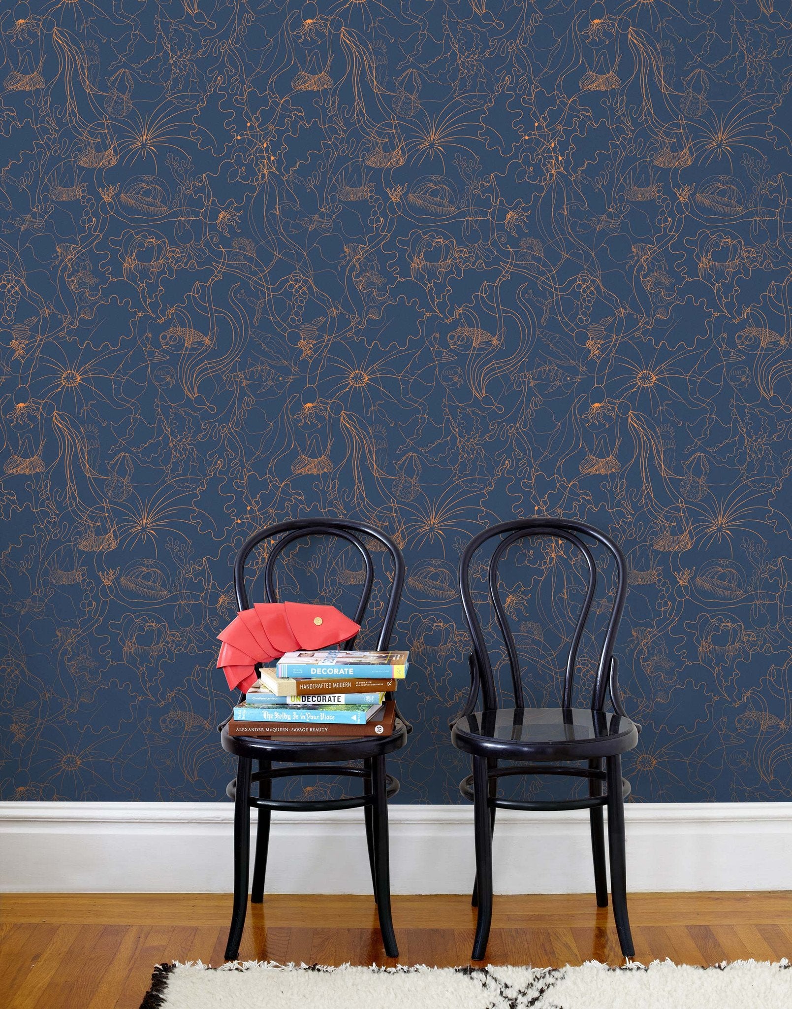 Underwater World (Deep Blue) features a yet delicate pattern of fish and seaweed in metallic copper on blue