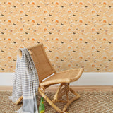 Amity Sunset (Blush) Wallpaper with pink, orange, and white illustrations depicts scenes from the iconic movie Jaws and was created in collaboration with Universal | Hygge & West